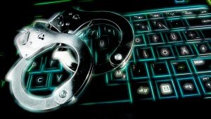 keyboard and handcuffs in neon green light