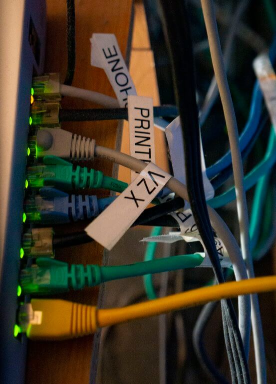 labeled patch cables in a network switch showing why a label maker is great for working on computers and networks